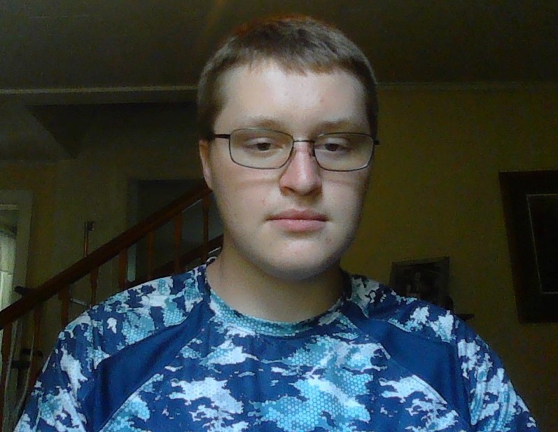 Zachary wearing a blue camo-style tshirt, facing forward.
