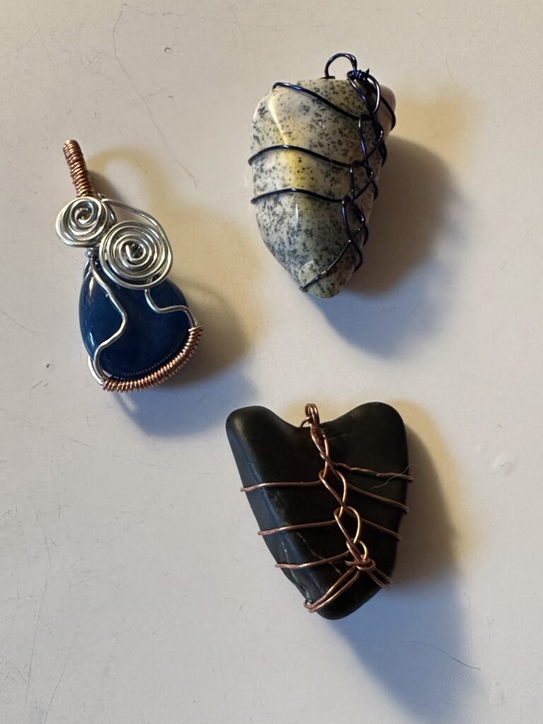 Three jewelry pieces made from wire and rocks