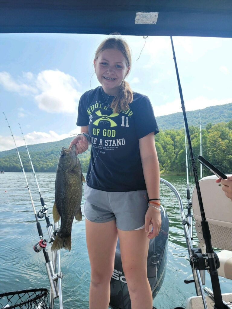 Karlie holding a fish that she caught